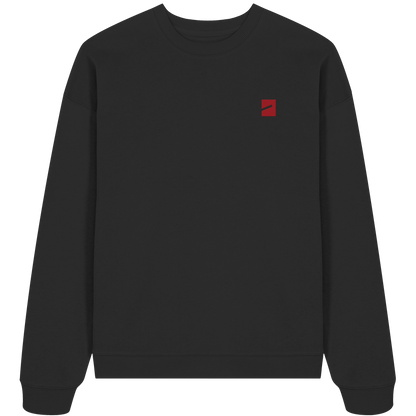 THE MARK · RED ED. Oversize Sweatshirt in Schwarz, Vorderansicht mit Marke auf der linken Brust in Dunkelrot
